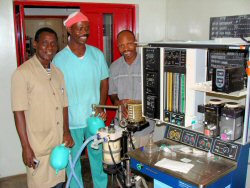   (left) From left, Joseph Edowhorhu, an anesthetist, and Segun Ogunlana taking in-service lessons on an anesthesia machine.