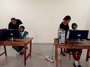 Two of the computers with students and instructors